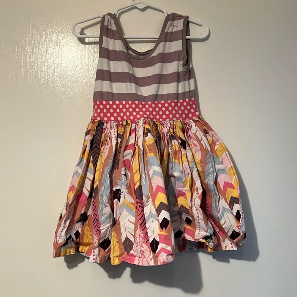 Colorful dress with feathers and stripes